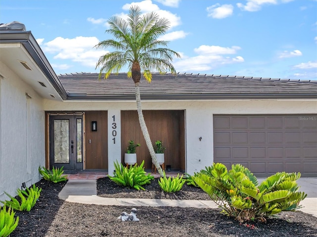 doorway to property with a garage