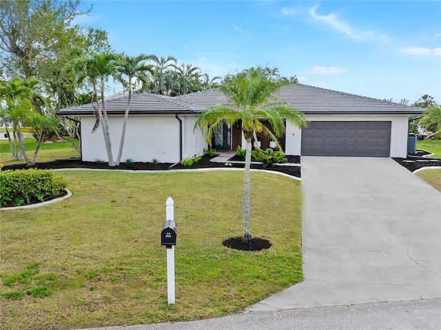 ranch-style home with a garage and a front lawn