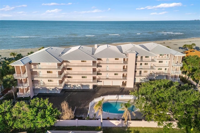 bird's eye view with a water view and a beach view