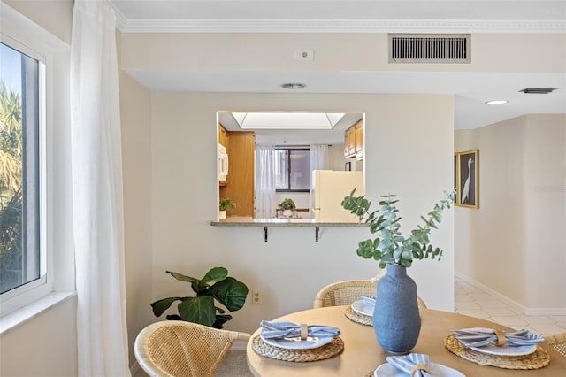 dining room featuring crown molding