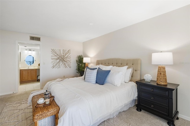 carpeted bedroom featuring ensuite bath