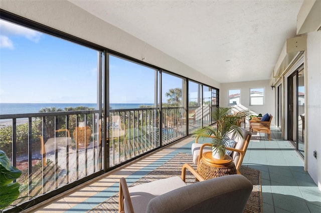 sunroom / solarium featuring a water view