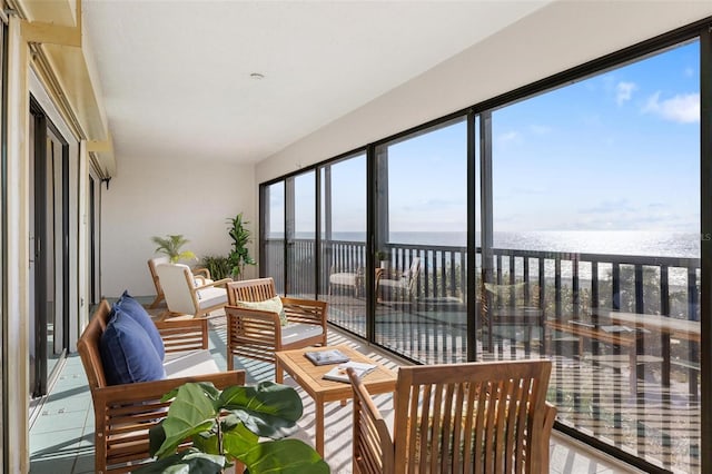 sunroom / solarium with a water view and plenty of natural light