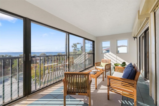 sunroom / solarium with a water view and plenty of natural light