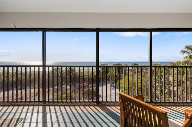 unfurnished sunroom with a water view