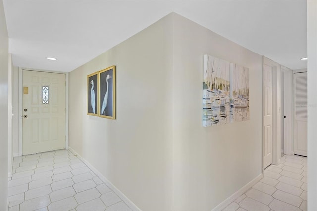 hall featuring light tile patterned floors