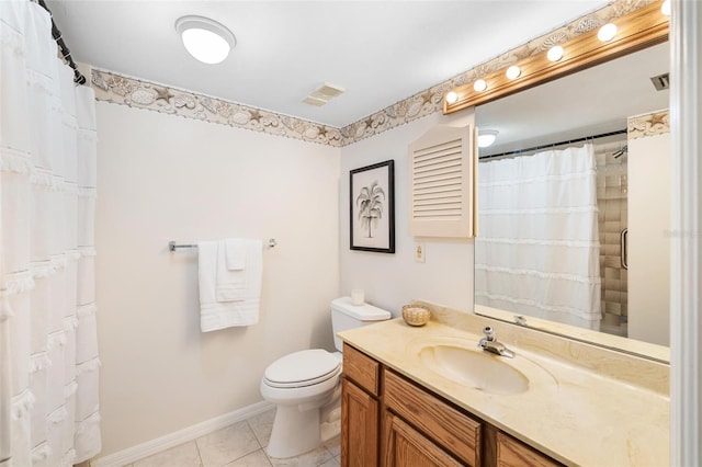 bathroom with vanity, toilet, tile patterned floors, and walk in shower