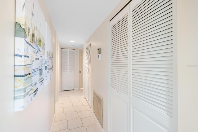 corridor featuring light tile patterned floors