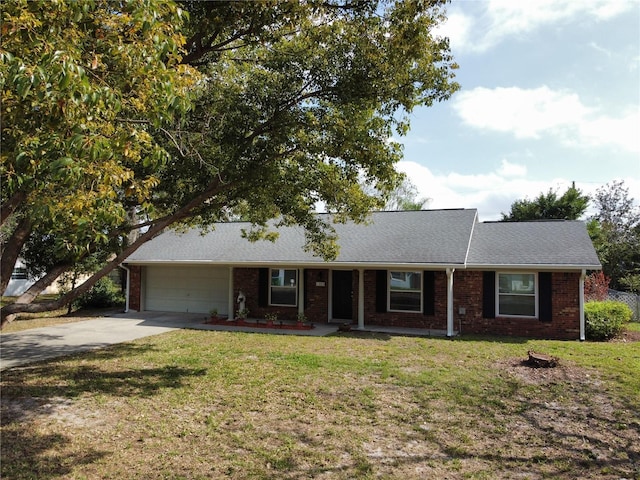 ranch-style house featuring a garage and a front yard