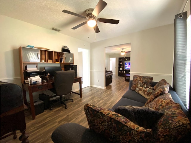 home office featuring ceiling fan, dark hardwood / wood-style floors, and a textured ceiling