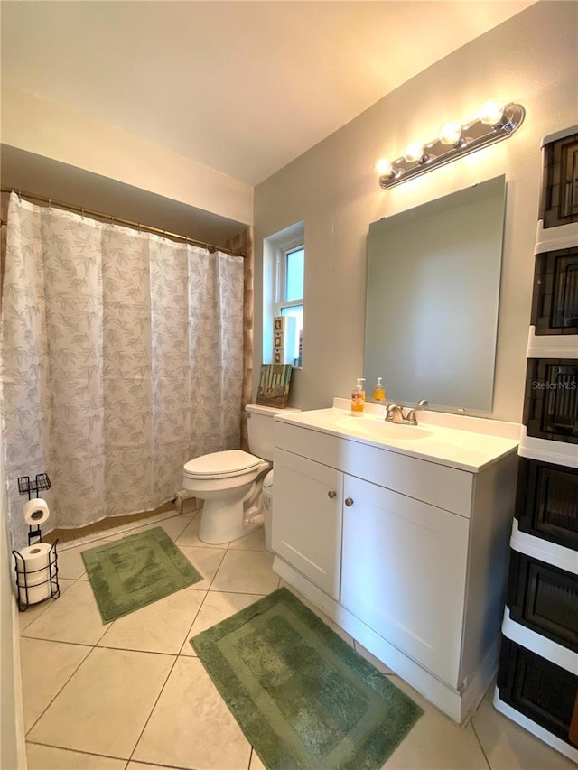 bathroom with vanity, tile patterned floors, and toilet