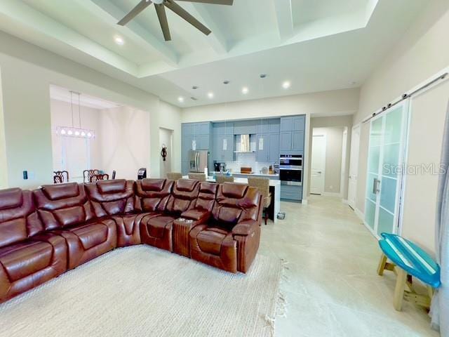 living area featuring recessed lighting, beamed ceiling, a high ceiling, and ceiling fan