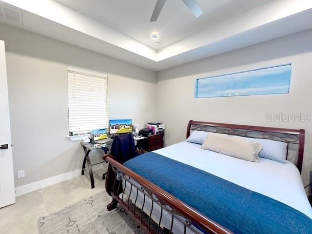 bedroom with recessed lighting, visible vents, a ceiling fan, baseboards, and a raised ceiling