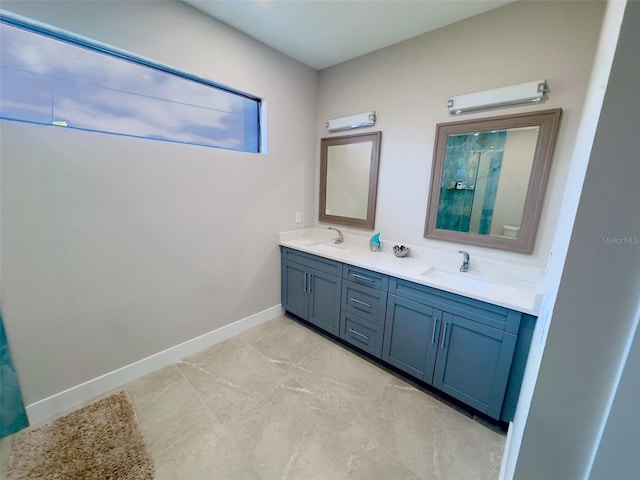 full bathroom featuring a shower, a sink, baseboards, and double vanity