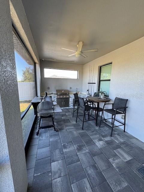 sunroom / solarium with ceiling fan