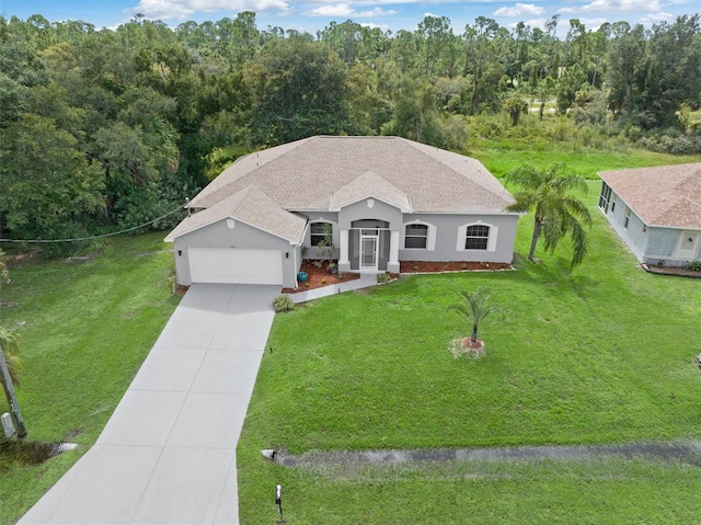 view of front of property featuring a garage and a front lawn