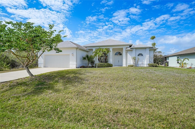 view of front facade with a garage and a front lawn