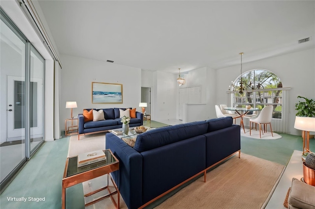 living room with carpet floors and a chandelier