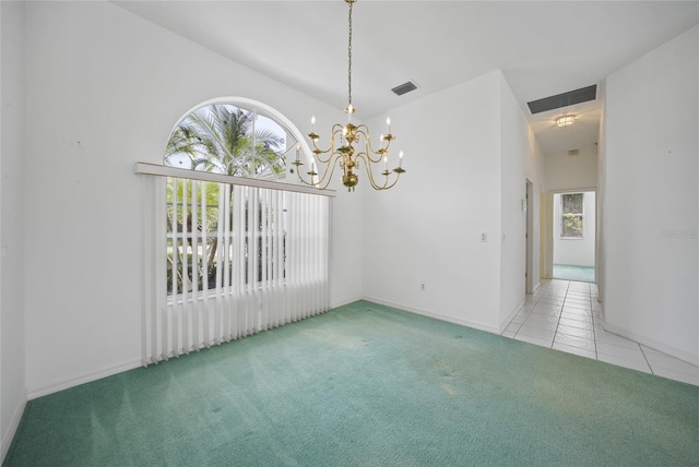 carpeted empty room with a chandelier and a high ceiling