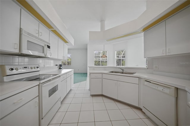 kitchen featuring tasteful backsplash, white appliances, sink, and white cabinets