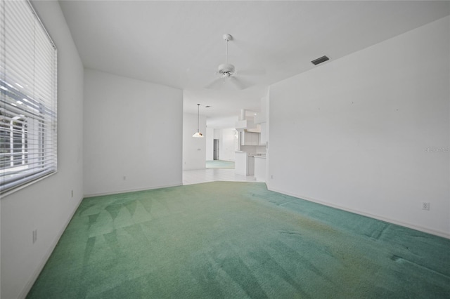 unfurnished living room featuring light colored carpet and ceiling fan