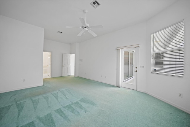 carpeted spare room with ceiling fan