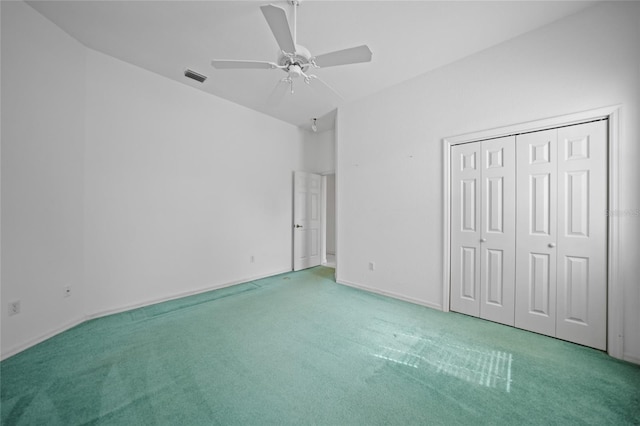 unfurnished bedroom featuring ceiling fan, a closet, and carpet