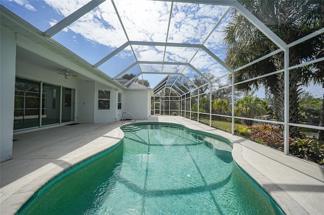 view of swimming pool with a patio, a lanai, and ceiling fan