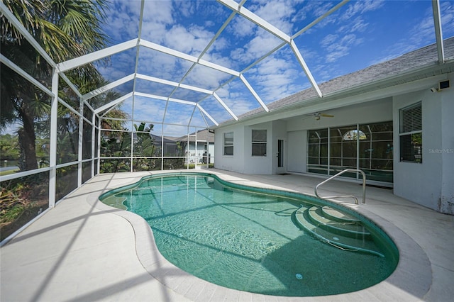 view of pool with a lanai, ceiling fan, and a patio area