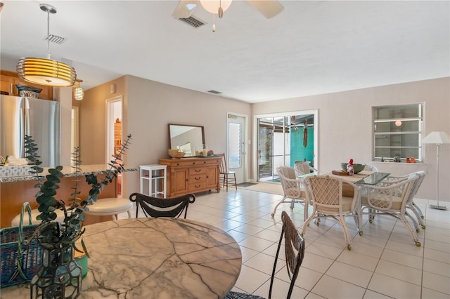 tiled dining room with ceiling fan