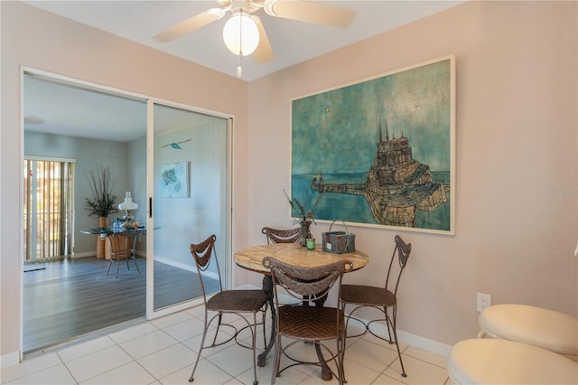 tiled dining room featuring ceiling fan