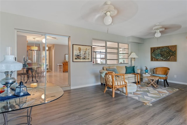 sitting room with hardwood / wood-style floors and ceiling fan