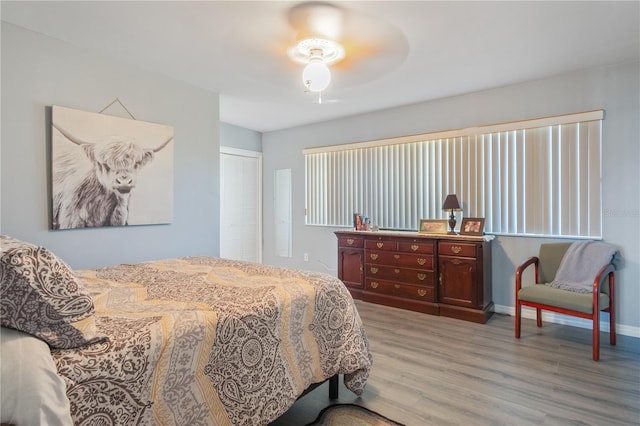 bedroom featuring hardwood / wood-style flooring, a closet, and ceiling fan