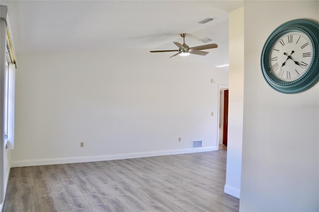 empty room with light wood-style floors, visible vents, and a ceiling fan