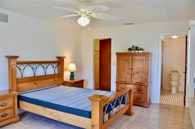 bedroom with ensuite bath, visible vents, and a ceiling fan