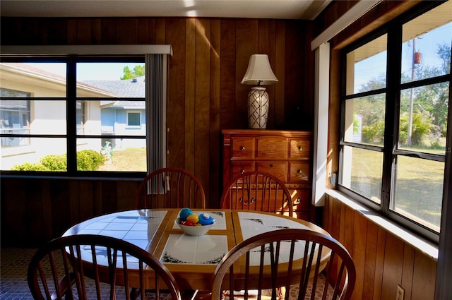 dining space featuring wooden walls