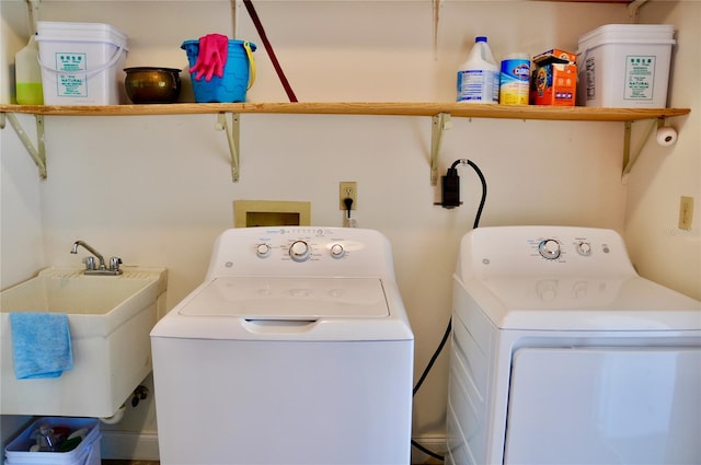 laundry room with laundry area, washer and clothes dryer, and a sink