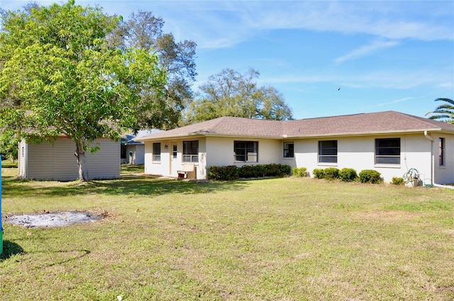 single story home featuring a front lawn and stucco siding