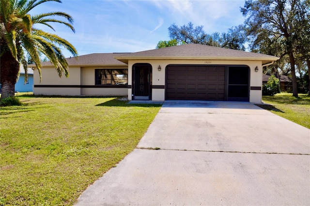 single story home featuring a garage, driveway, a front lawn, and stucco siding