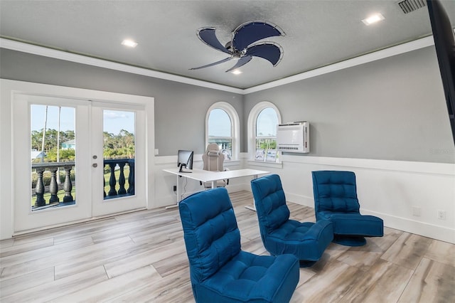 sitting room featuring ceiling fan, a wealth of natural light, crown molding, and french doors