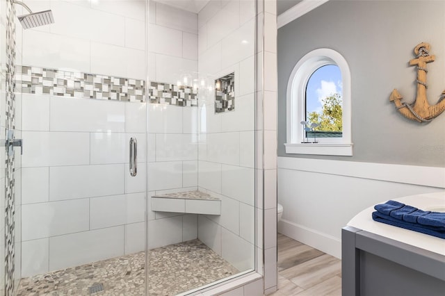 bathroom with wood-type flooring, toilet, and walk in shower