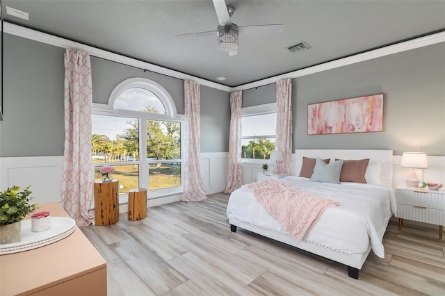 bedroom featuring ornamental molding, ceiling fan, and light hardwood / wood-style flooring