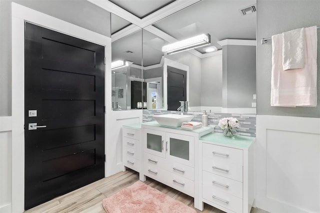 bathroom featuring vanity, crown molding, and wood-type flooring