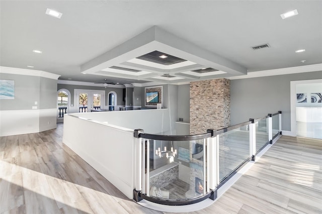 corridor with beam ceiling, light hardwood / wood-style flooring, french doors, crown molding, and coffered ceiling