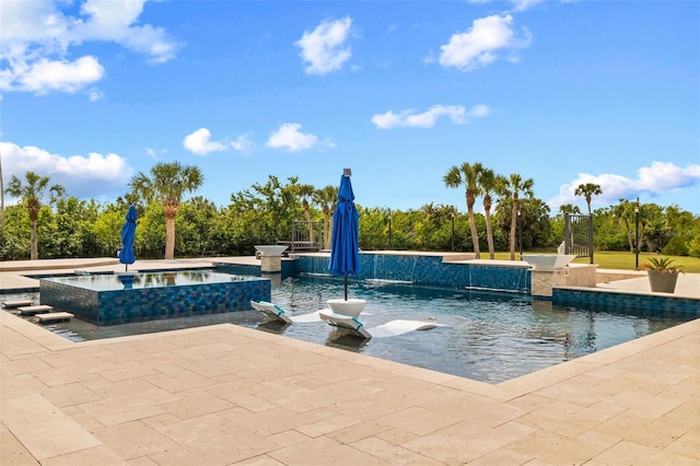 view of community with a pool with hot tub and a patio area