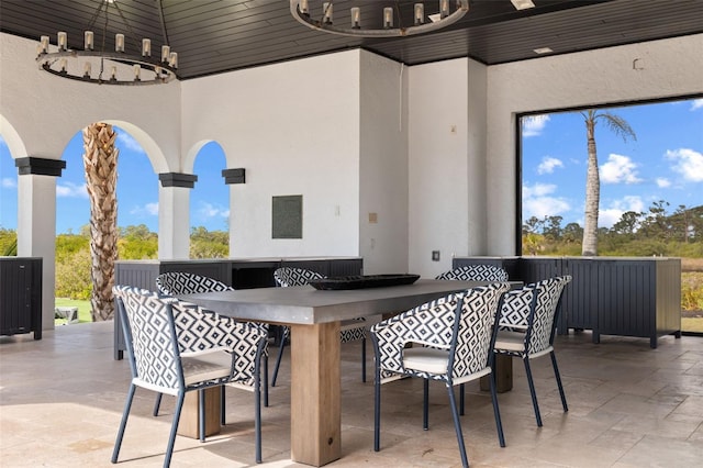 view of patio / terrace with ceiling fan and a bar