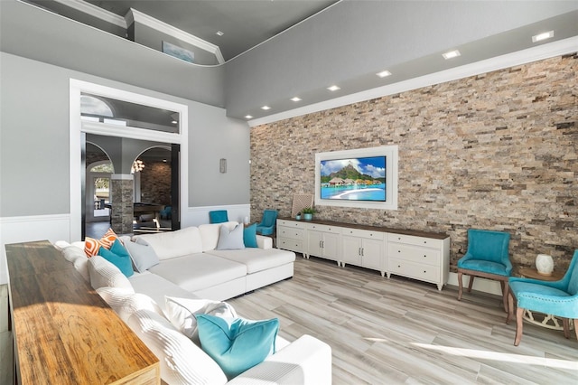 living room featuring ornamental molding and light hardwood / wood-style floors