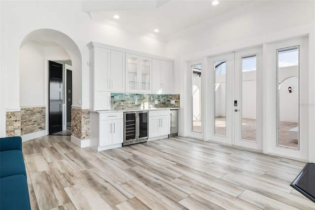 bar featuring white cabinetry, french doors, sink, and wine cooler