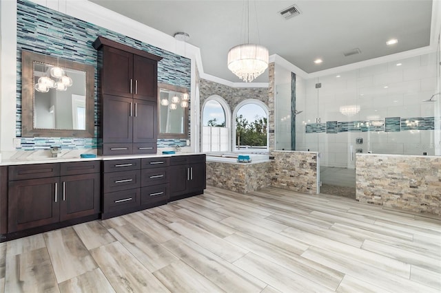 bathroom featuring separate shower and tub, crown molding, a chandelier, and vanity