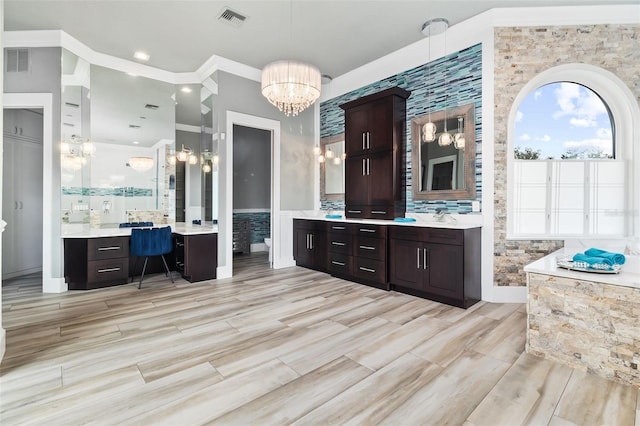 bathroom with vanity and an inviting chandelier